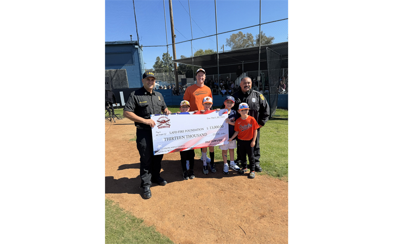 Coach Hains and the 2025 AA Orioles present the LAFD Battalion 10 with a check for $13,000. 